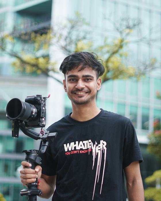 A video creator holding a camera on a stabilizer