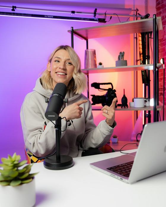 A podcaster at her desk with a microphone
